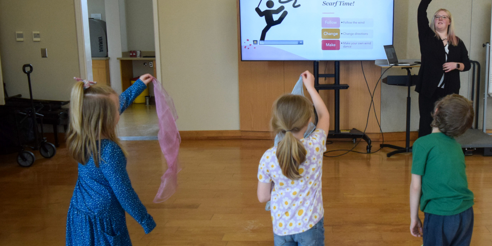 Students following teaching artist Macy Morgan